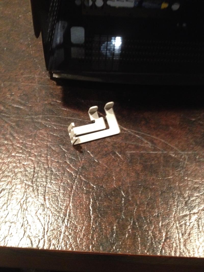 A special piece of plastic which would have been in the original case to act as a button that can press reset and break buttons on the computer's motherboard.