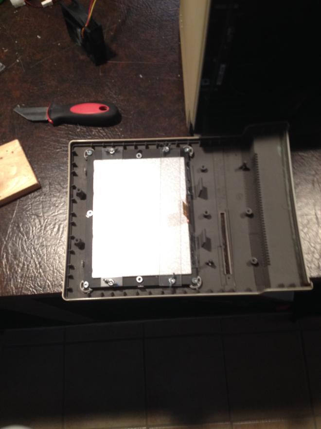 Front bezel of a Mac case with several laser-cut acrylic pieces installed to hold an LCD screen in place.