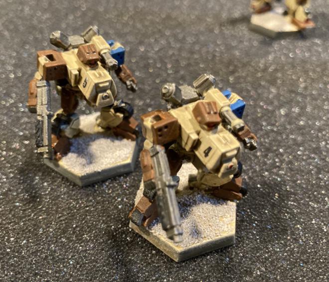 Two Bobcat Heavy Gear miniatures.