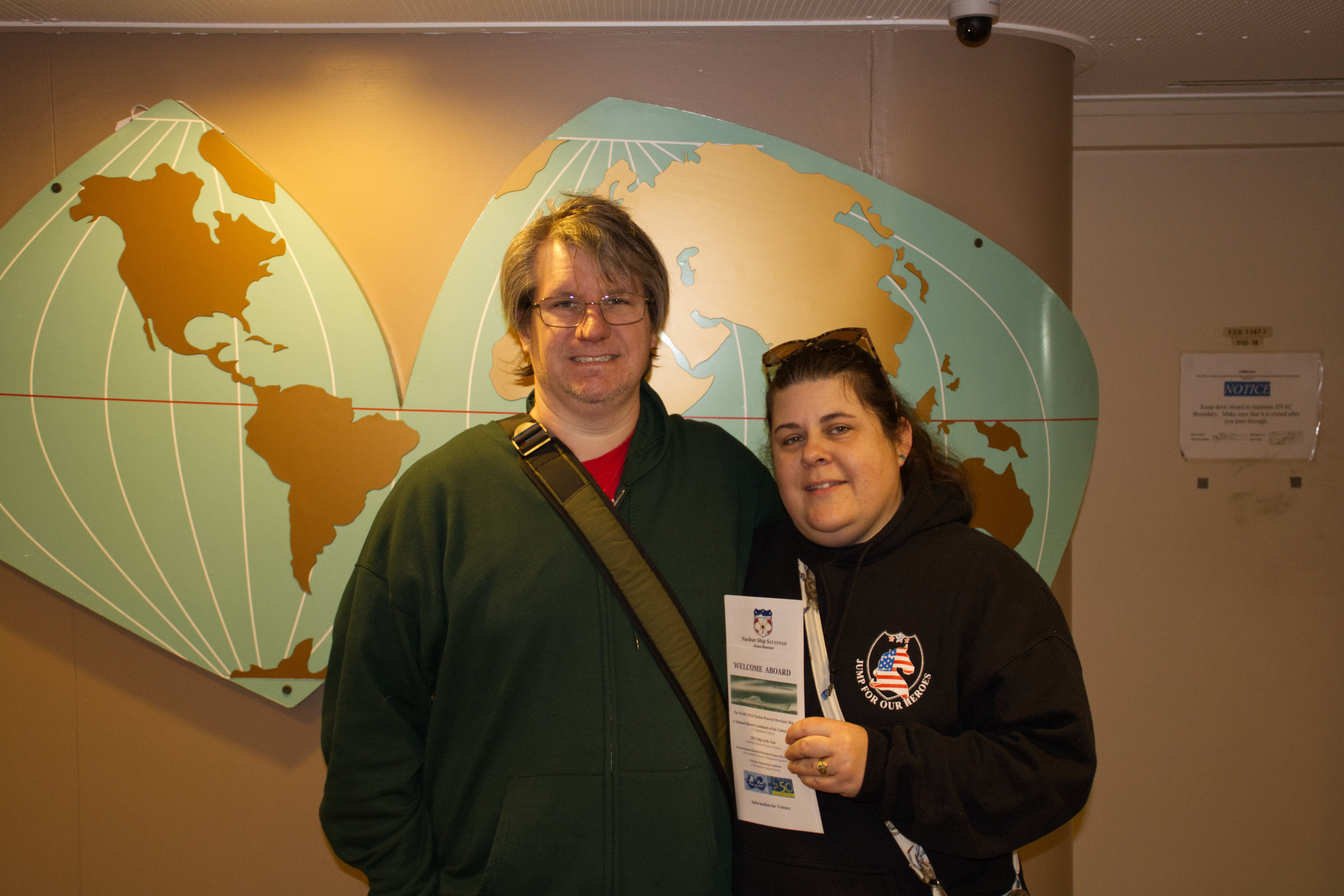 My wife and I standing in front of a period world map adorning one wall of the lobby.