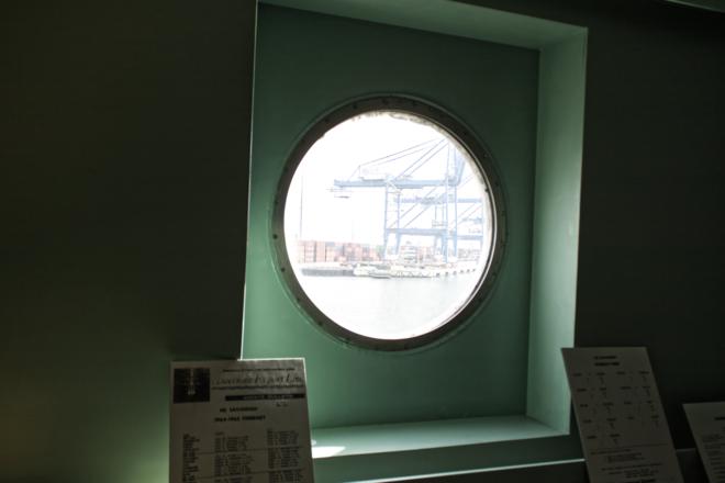 A porthole showing the Baltimore docks.